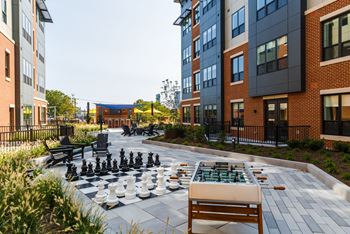 A chess board in the middle of an apartment courtyard